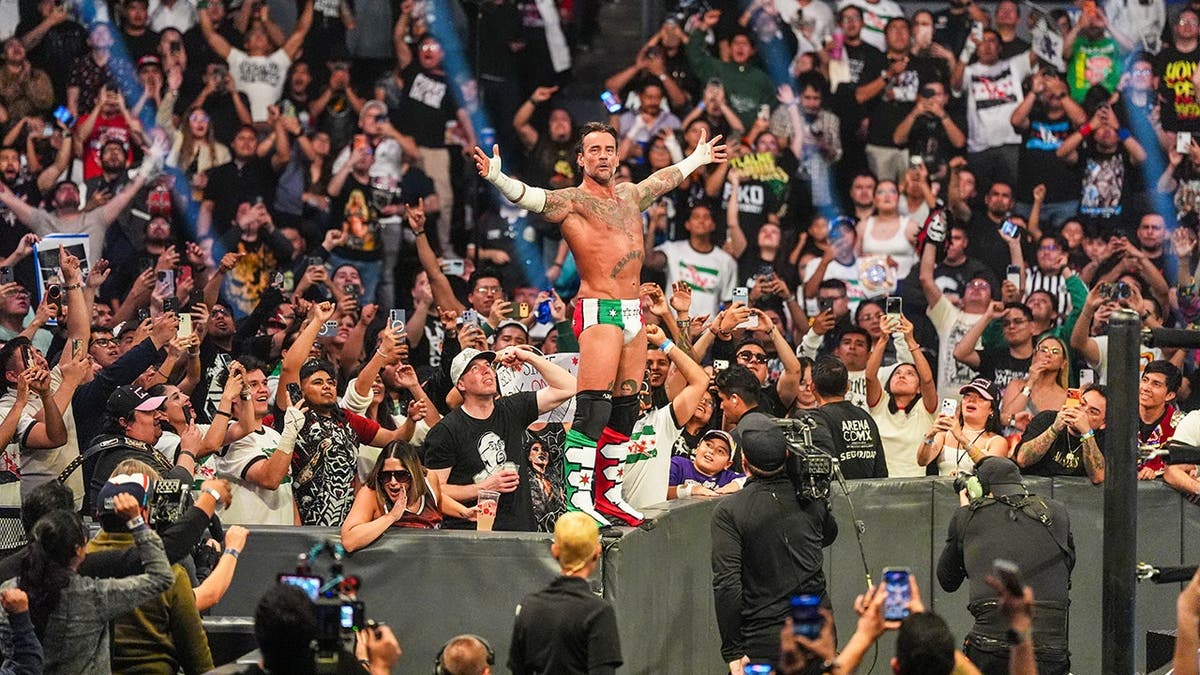 CM Punk celebrates with the crowd during SmackDown at Arena Ciudad de Mexico.