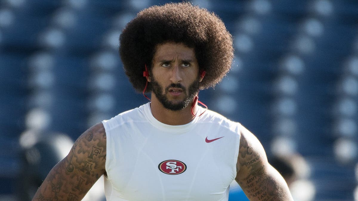 Colin Kaepernick warms up before a preseason game in San Diego.