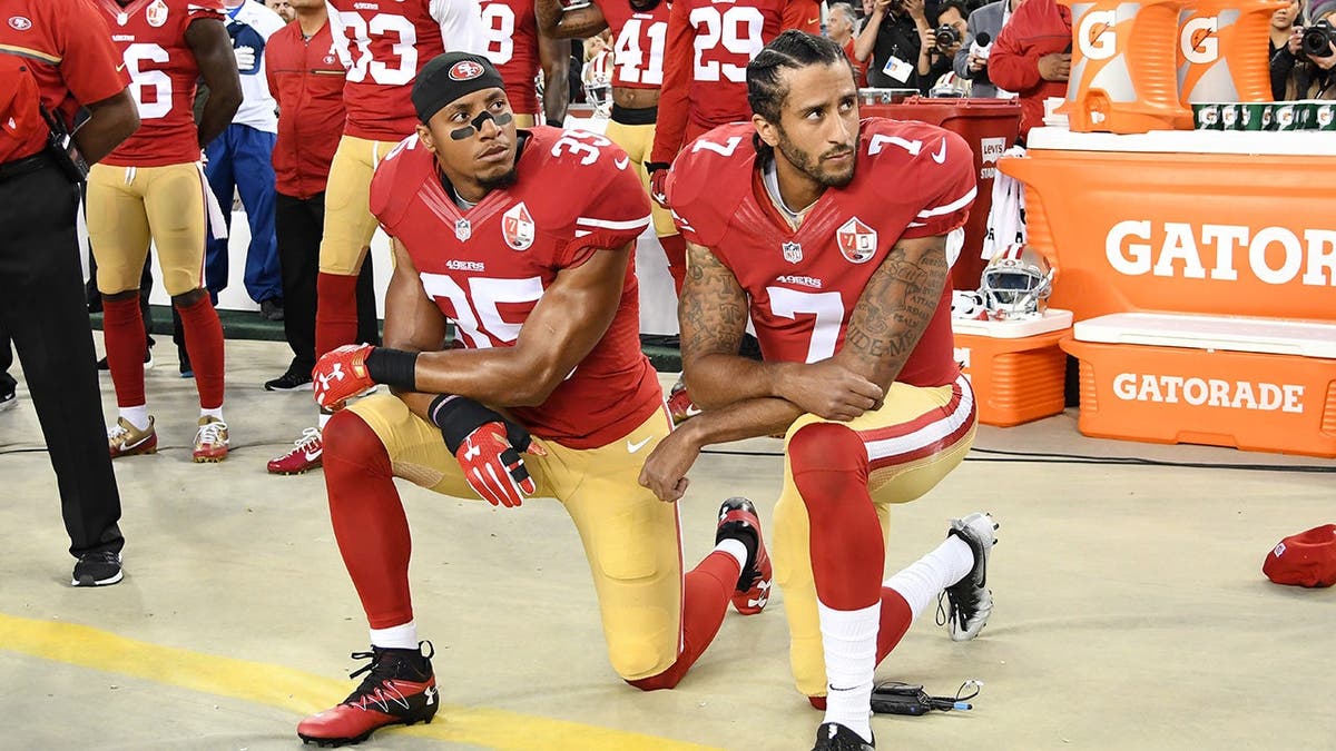 Colin Kaepernick and Eric Reid kneel during the national anthem at Levi's Stadium.