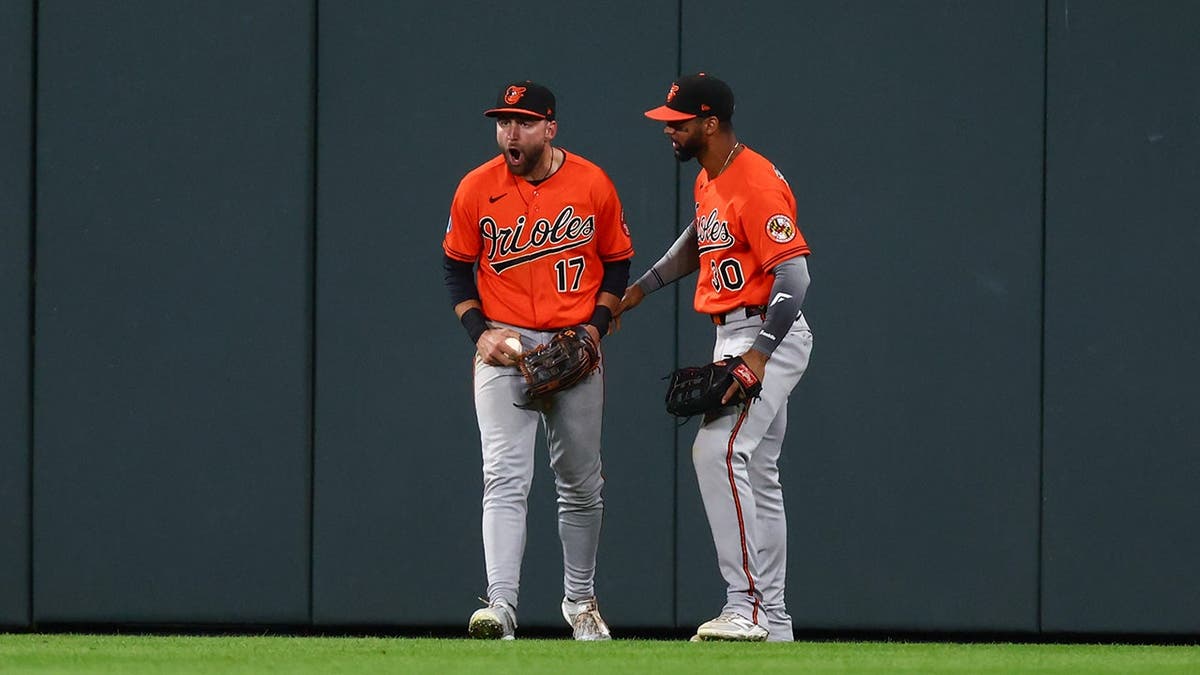 Colton Cowser and Leody Taveras celebrate after robbing a home run at Coors Field.