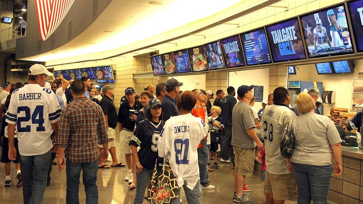 Fans order at a concessions stand inside Cowboys Stadium.