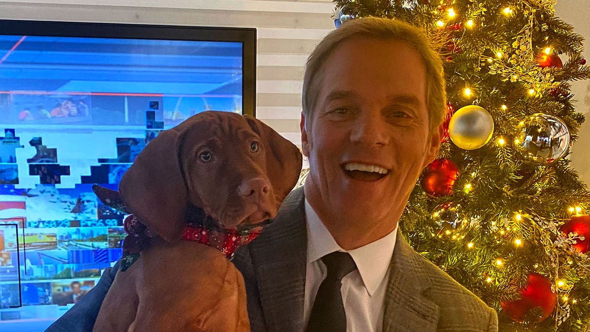 America's Newsroom co-host Bill Hemmer with Dana Perino's dog Percy as a puppy.
