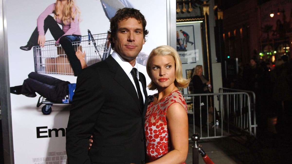 Dane Cook and Jessica Simpson stand together at a premiere event in Hollywood.