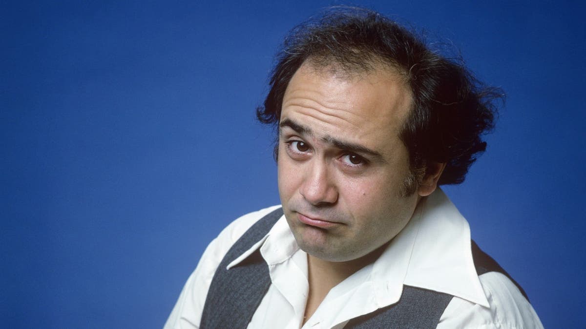 Danny DeVito as Louie stands in a portrait from the television comedy Taxi.