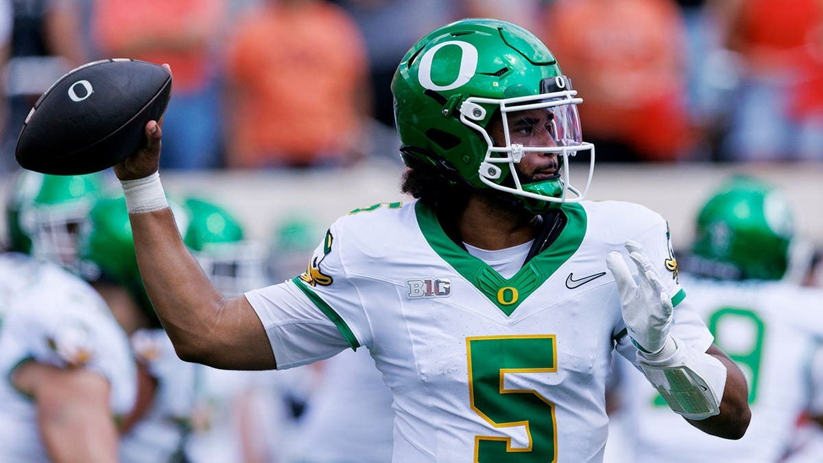 Dante Moore throws a pass during the first quarter at Boone Pickens Stadium.