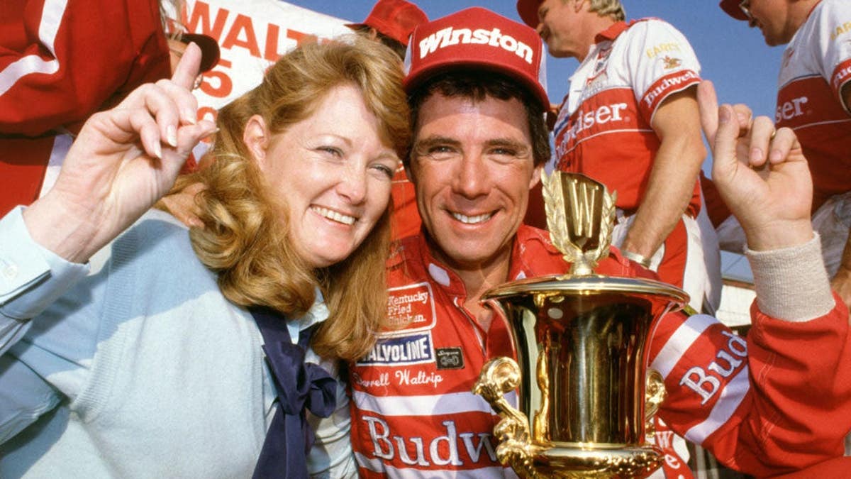 Darrell Waltrip celebrates with wife Stevie and teammates at Riverside Speedway.