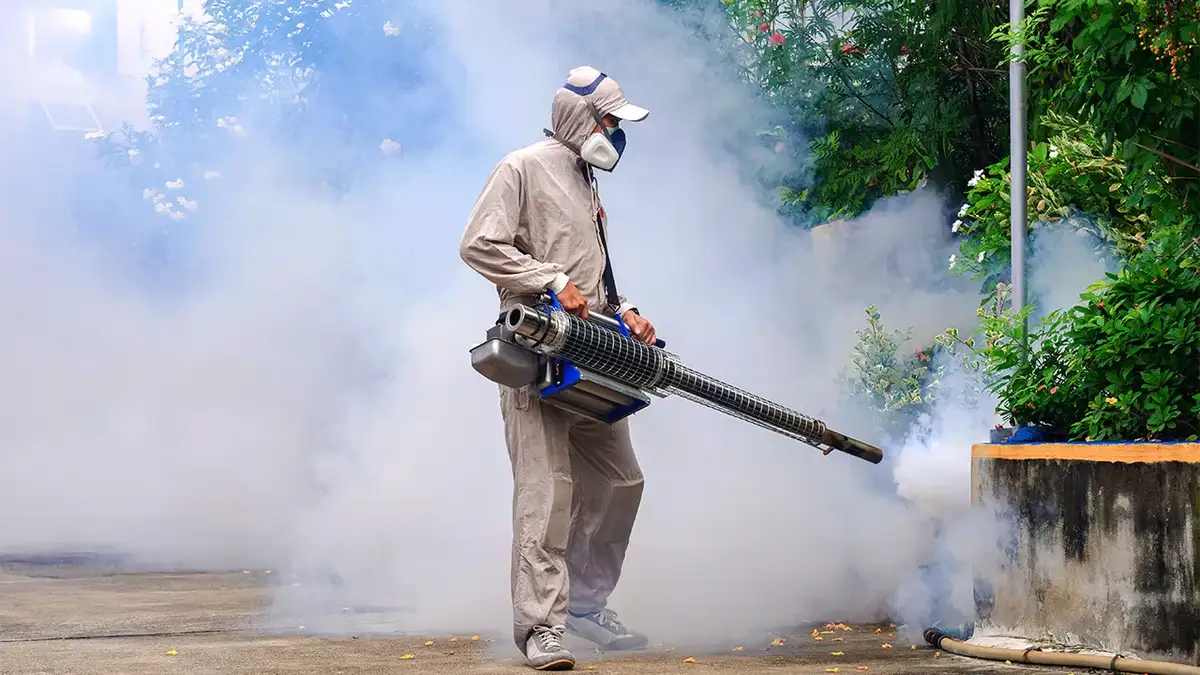 A man sprays insecticide.