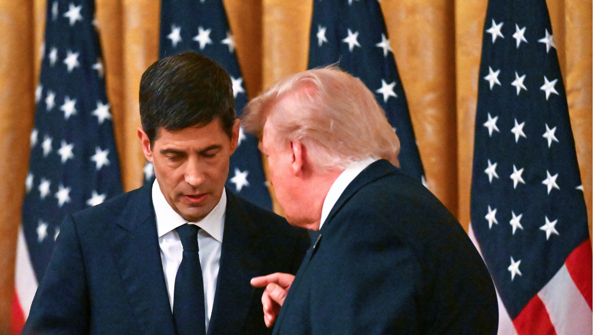 U.S. President Donald Trump speaks to Kevin Warsh (L) after he was sworn in as the new Chairman of the Federal Reserve.
