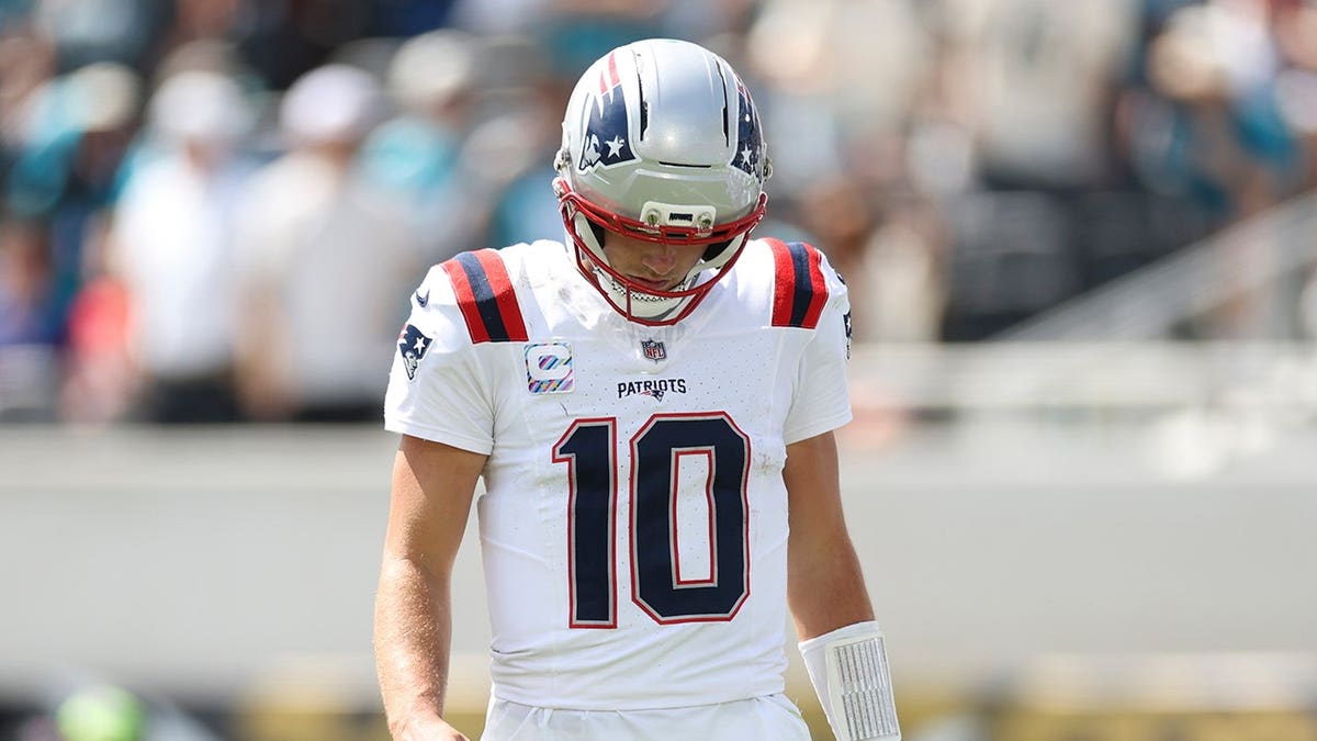 Drake Maye #10 of the New England Patriots looks on during an NFL game.