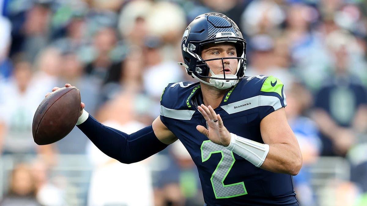 Drew Lock of the Seattle Seahawks looks to throw a pass against the New England Patriots.