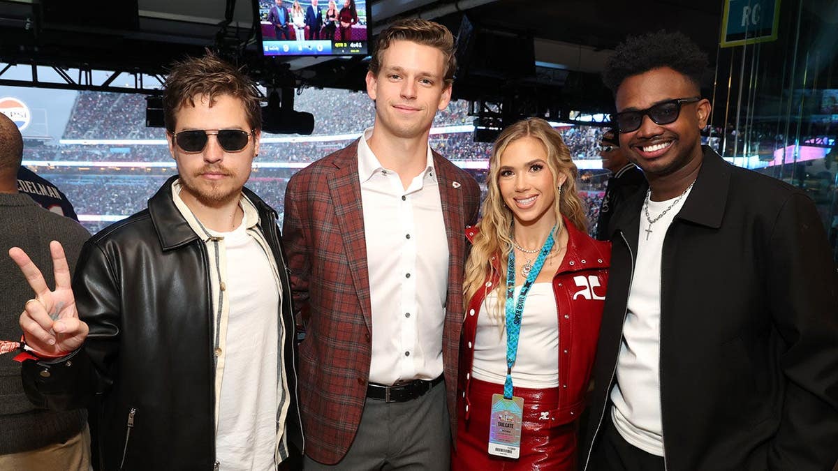 Gracie Hunt stands with Dylan Sprouse, Derrick Green and CJ Cook at Levi's Stadium.