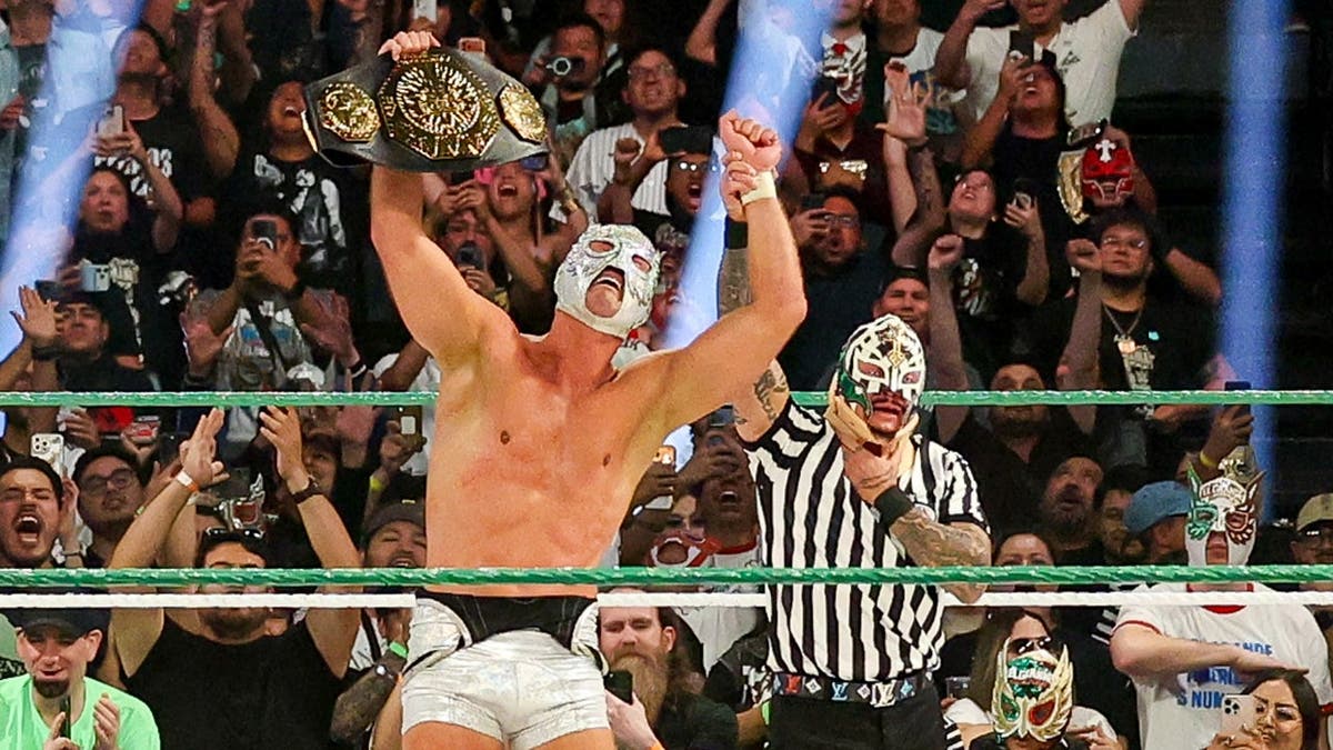 El Grande Americano celebrates with Rey Mysterio after winning the AAA Mega Championship.