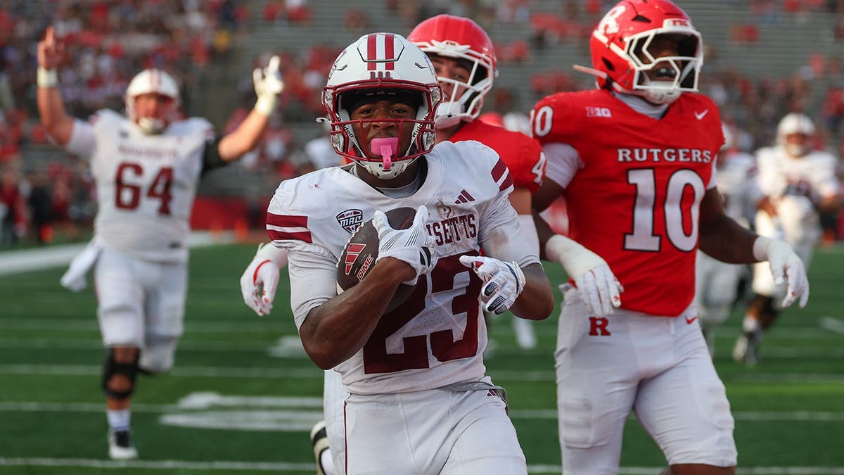 Elijah Faulkner #23 runs for a touchdown during a college football game against Rutgers.