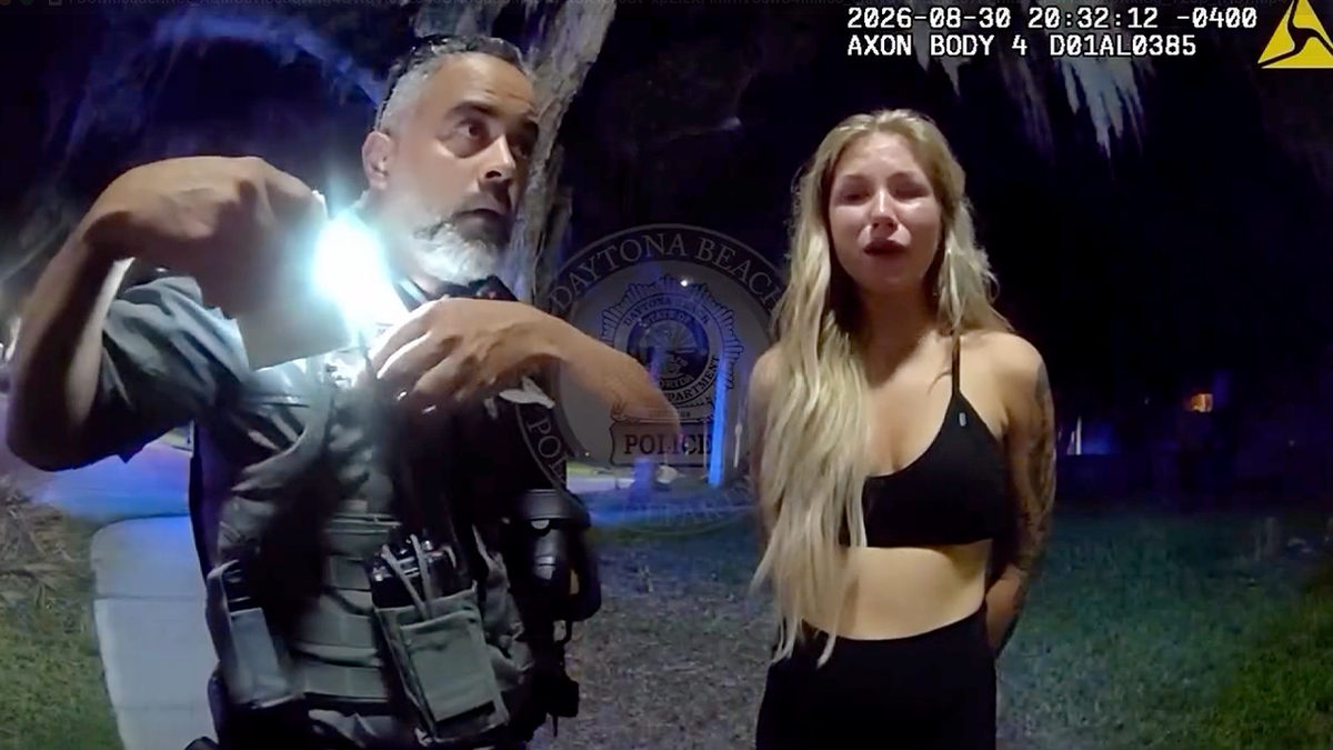 Elizabeth Boucher speaks with a Daytona Beach police officer before her arrest