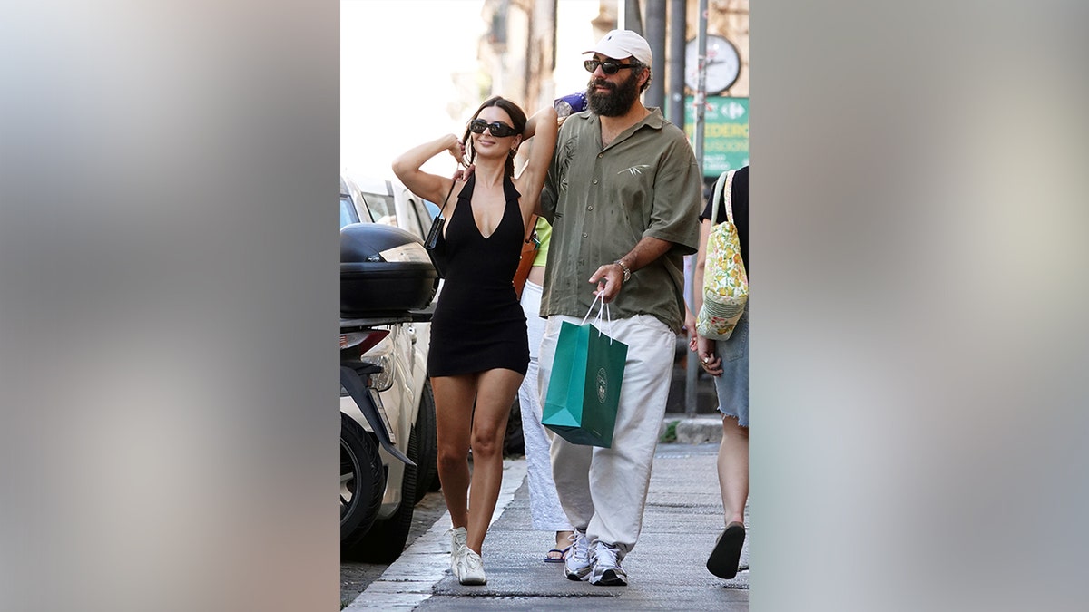 Emily Ratajkowski and Romain Gavras walking around in Rome.