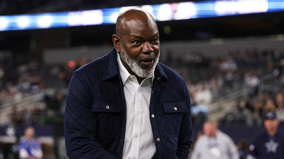 Emmitt Smith looks on from the field at AT&T Stadium.