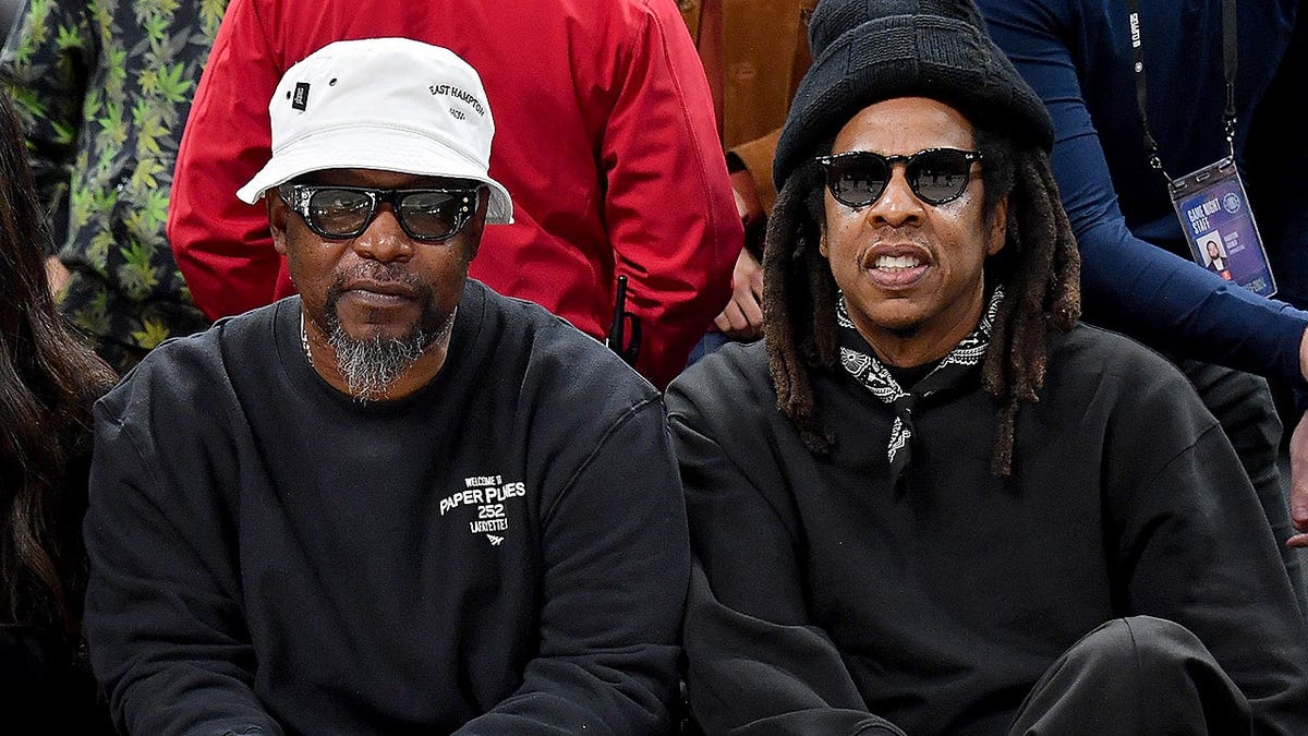 Jay-Z and Emory Jones seated at a basketball game between the Los Angeles Clippers and Lakers.