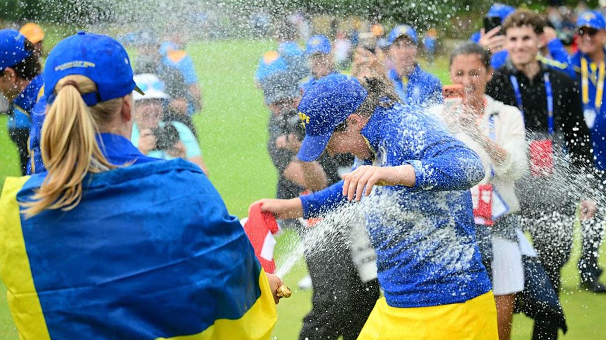 Team Europe's players spray champagne