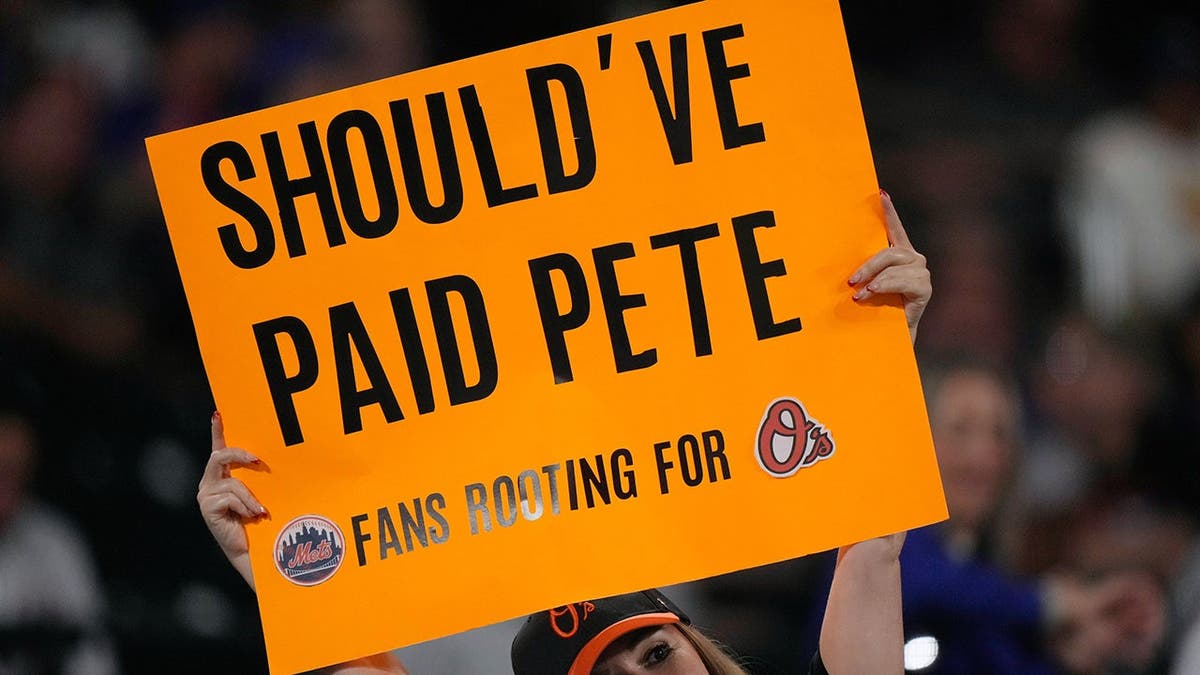 A fan holds up a sign during a baseball game between the Mets and Orioles in New York.