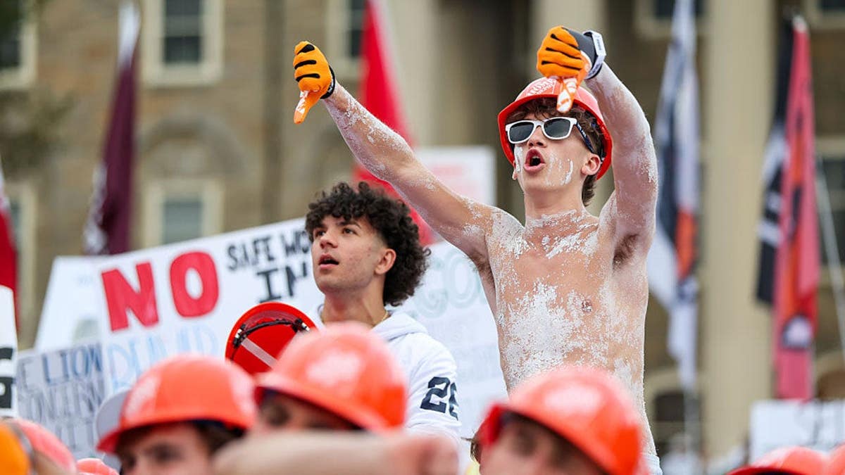 Fan gives thumbs down during ESPN's College GameDay at Penn State.