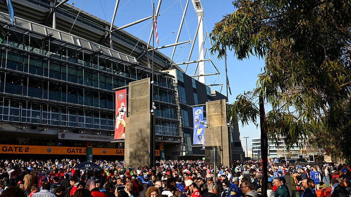 Fans gather outside the MCG before the San Francisco 49ers and Los Angeles Rams game.