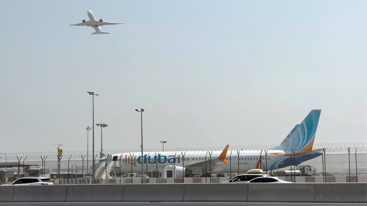 flydubai aircraft sits on the tarmac at Dubai International Airport in Dubai