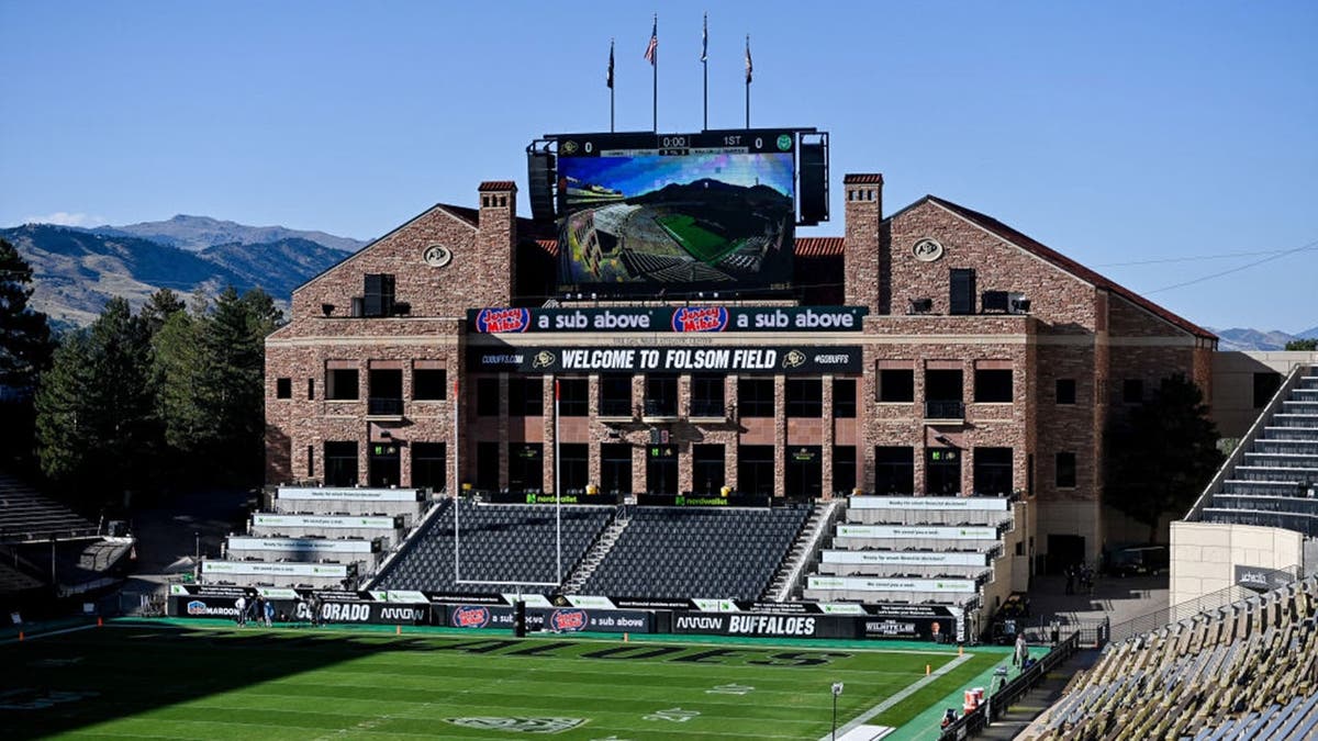 Video scoreboard and empty stands visible inside Folsom Field before a game.