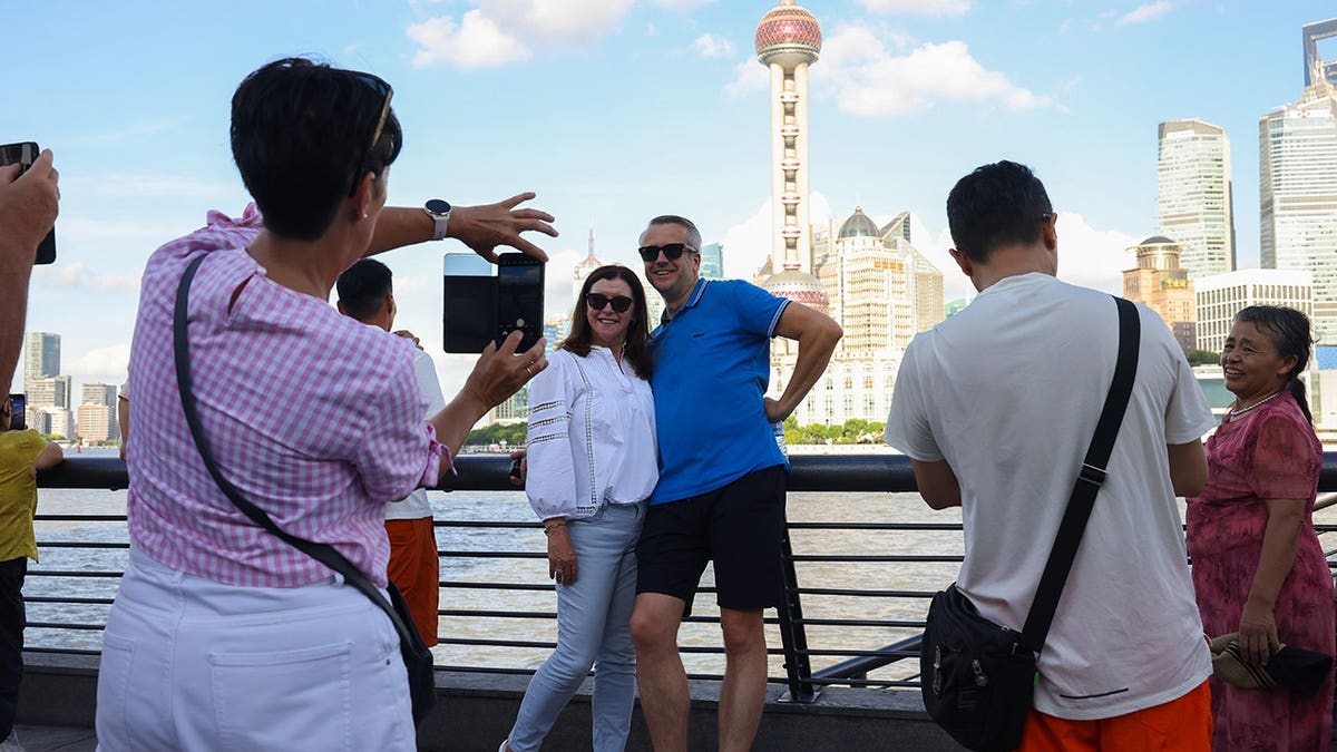 Foreign tourists visit the Bund in Shanghai, China.