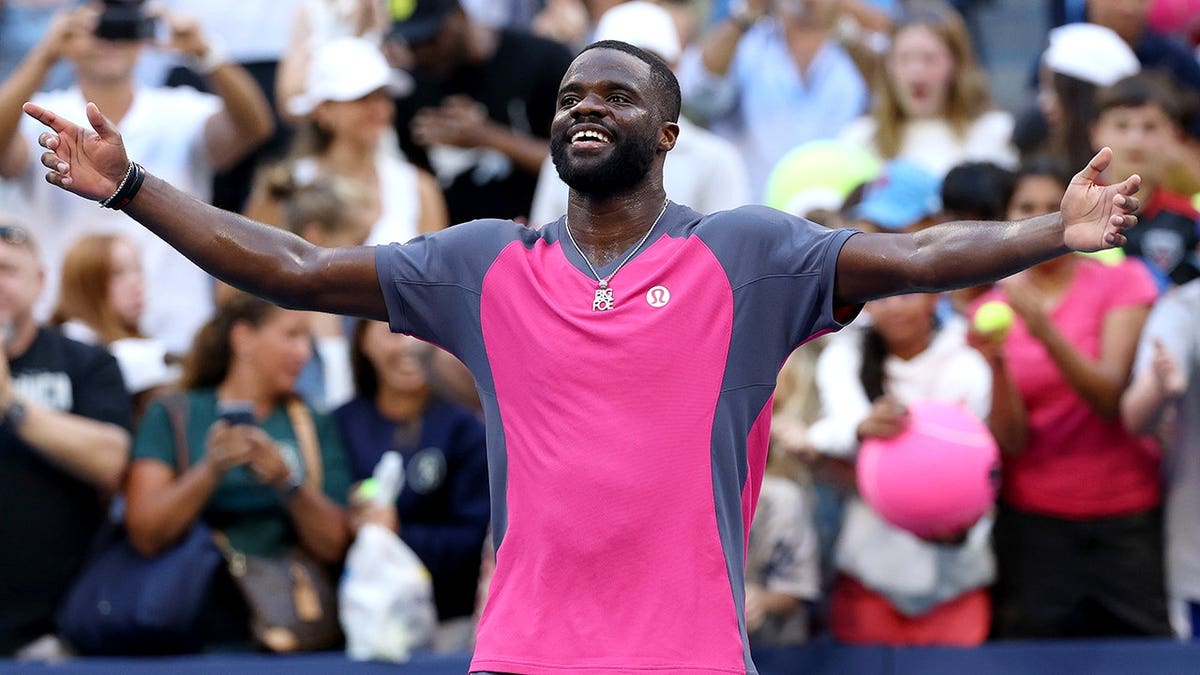 Frances Tiafoe reacts after defeating Daniil Medvedev in a US Open tennis match.
