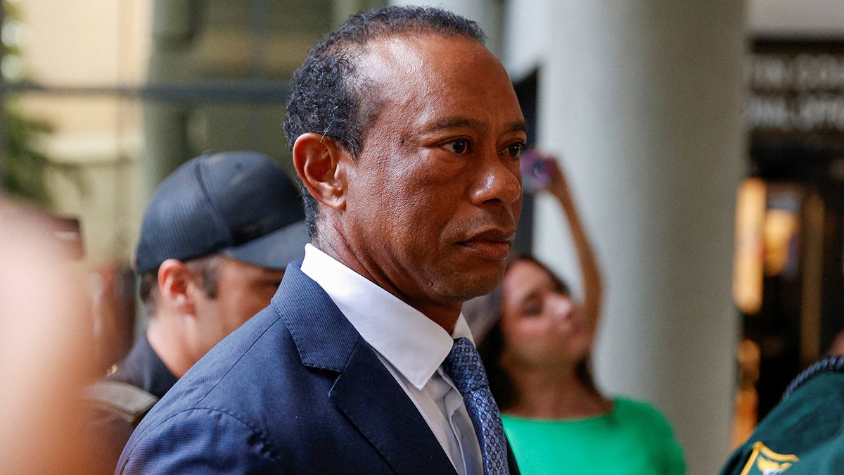 Tiger Woods enters a Florida courthouse