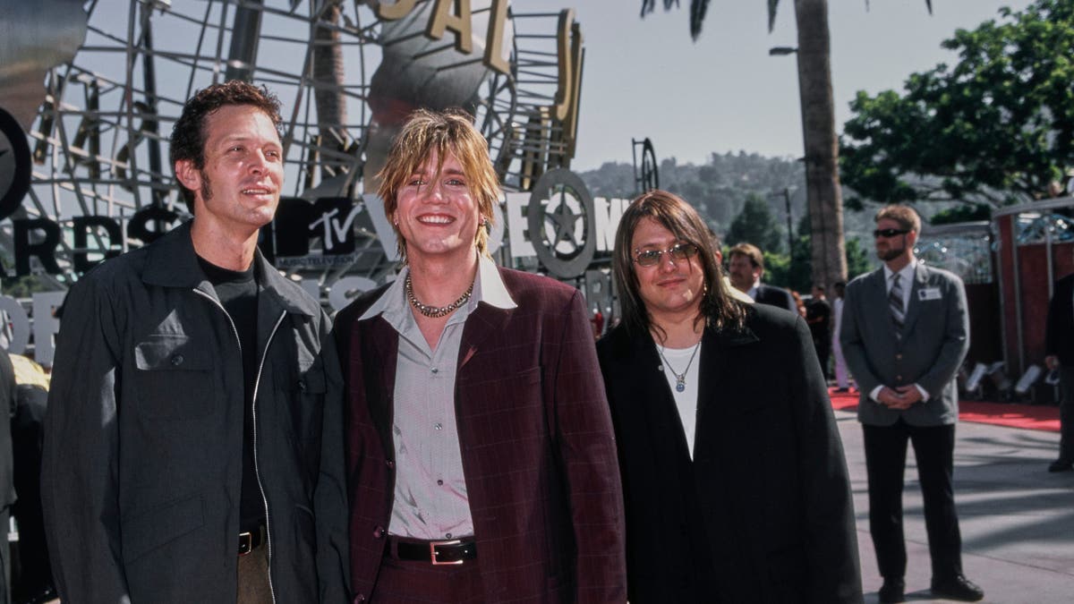 Goo Goo Dolls members Mike Malinin, John Rzeznik, and Robby Takac stand together at the MTV Video Music Awards.