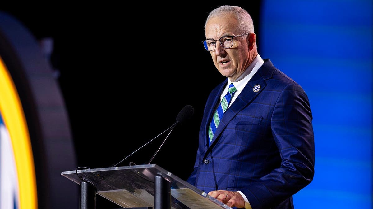Greg Sankey speaks at a podium during SEC Football Media Day in Tampa.