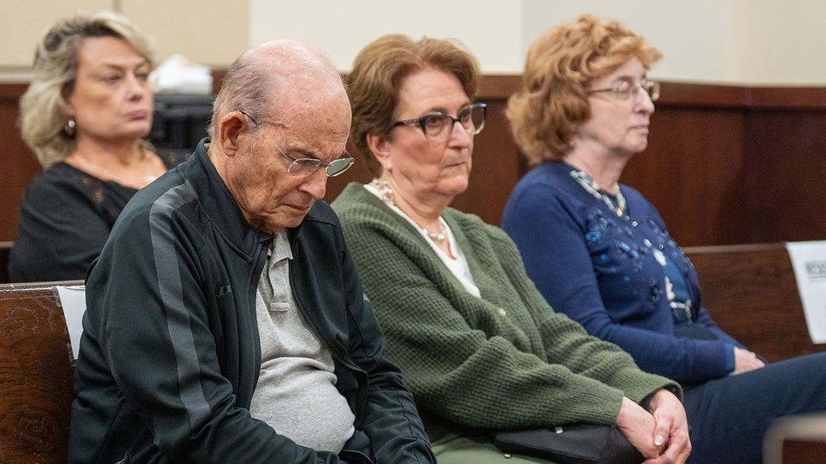 Harvey Adelson hangs his head in a courtroom as a guilty verdict is read for his wife, Donna Adelson.