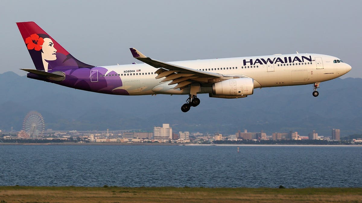 Hawaiian Airlines Airbus A330-200 with registration N380HA approaches Osaka Kansai Airport.