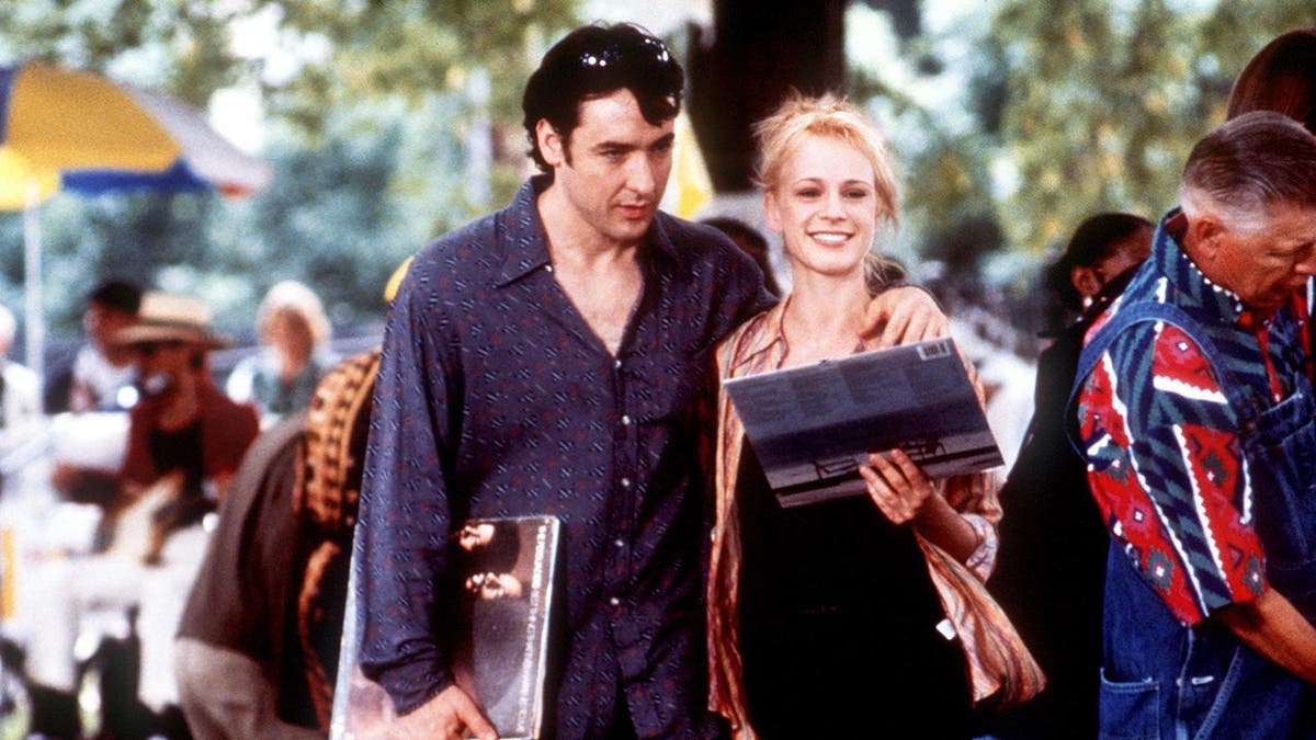 John Cusack and Iben Hjejle stand together in a scene from High Fidelity.