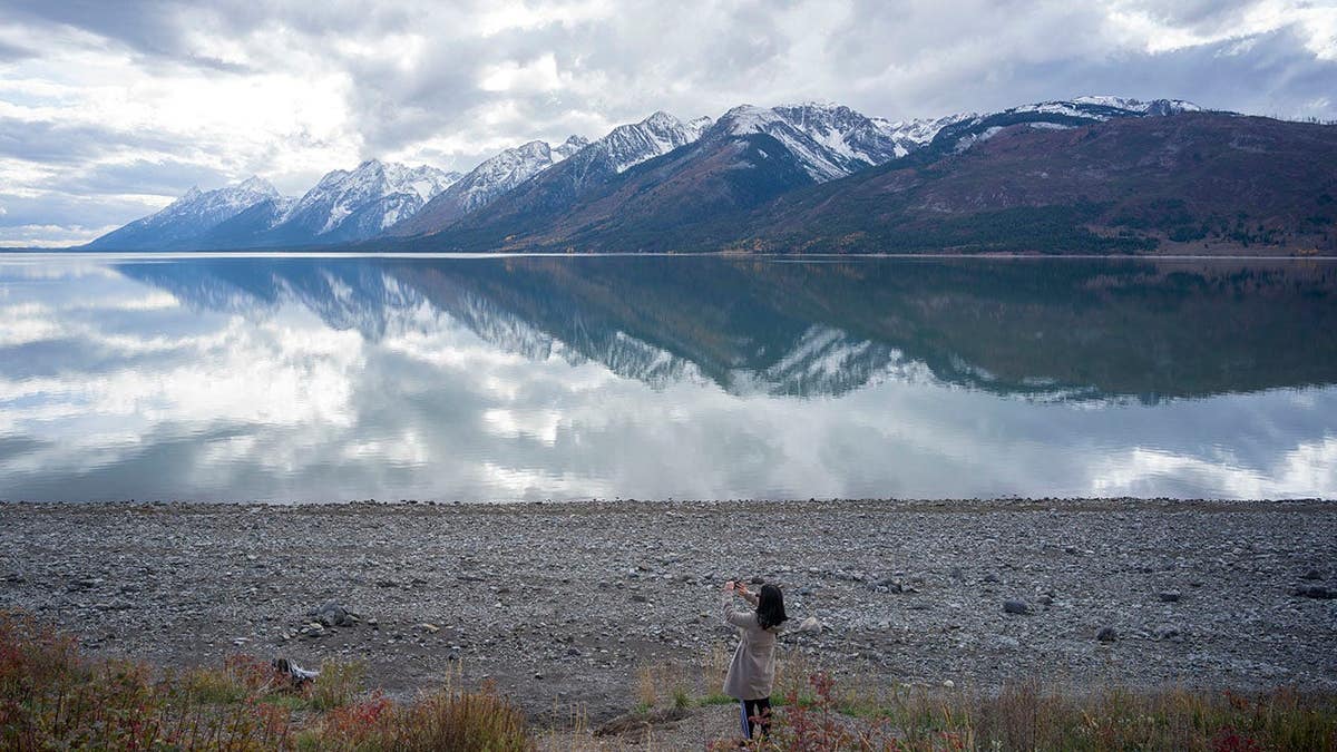 Hong Ge takes a photo of Jackson Lake in Grand Teton National Park, Wyoming.