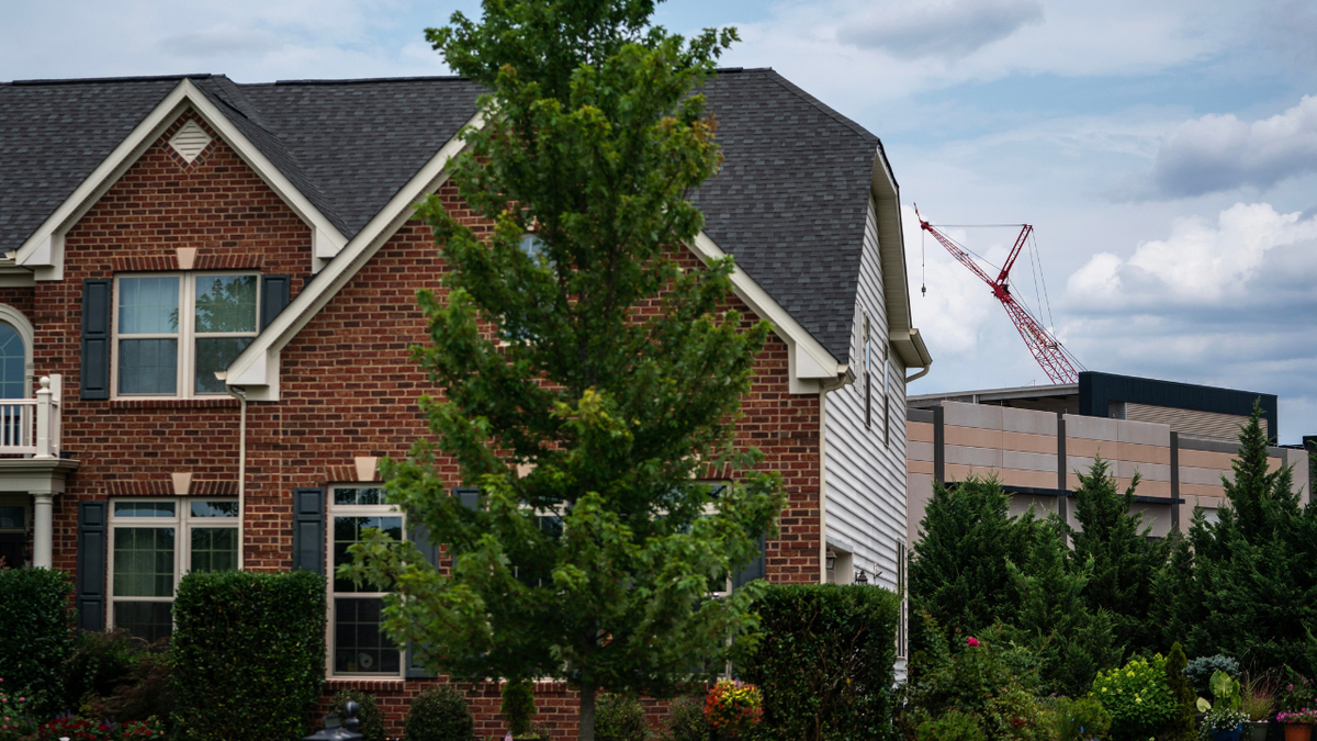 An Amazon Web Services data center is shown behind a single-family home on July 17, 2024 in Stone Ridge, Virginia.