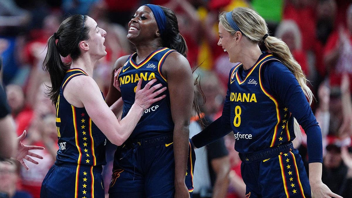 Caitlin Clark congratulates Raven Johnson after a basket against the Las Vegas Aces.