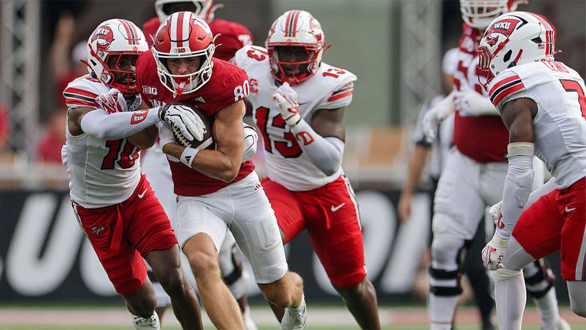 BLOOMINGTON, INDIANA - SEPTEMBER 19: Charlie Becker #80 of the Indiana Hoosiers runs the ball against Xavion "Tutu" Griffin #10 of the Western Kentucky Hilltoppers during the second half at Memorial Stadium on September 19, 2026 in Bloomington, Indiana.
