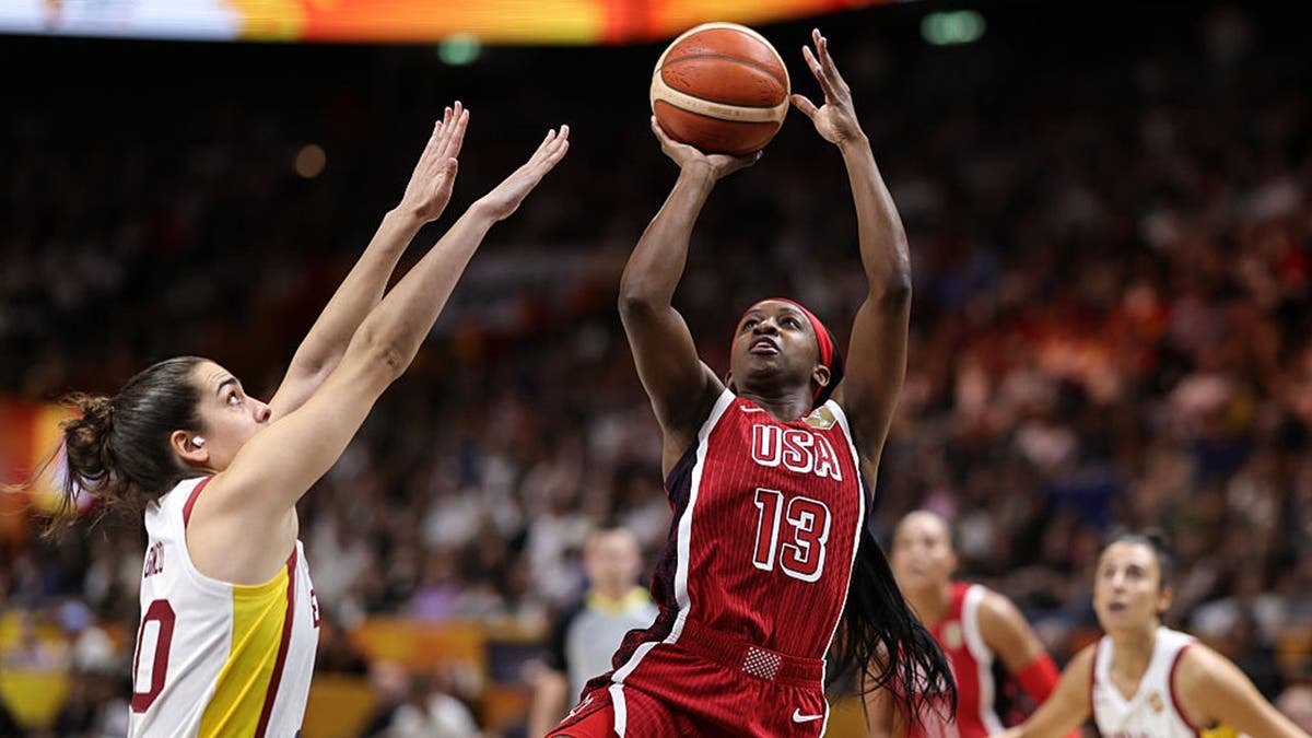 Jackie Young and Maria Conde stand on the court during a FIBA Women's Basketball World Cup game.