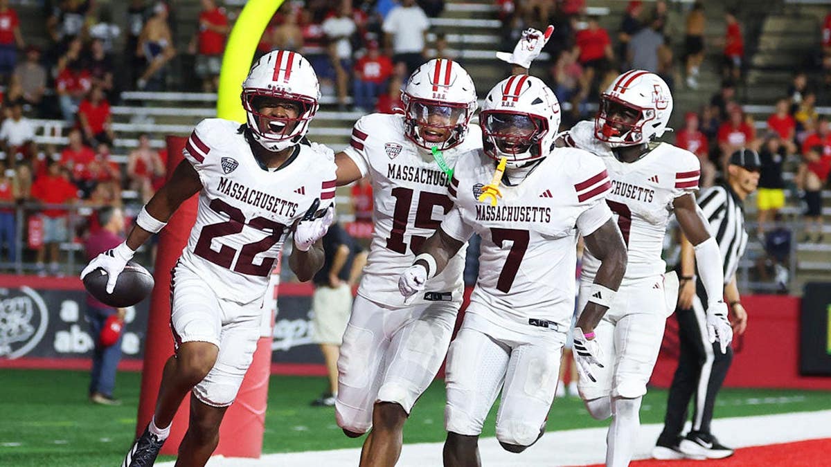 Jahmad Harmon #22 celebrates his interception during a college football game.