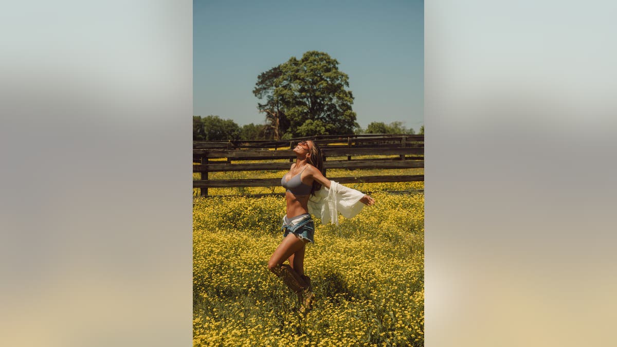 Jana Kramer wears blue bra in field
