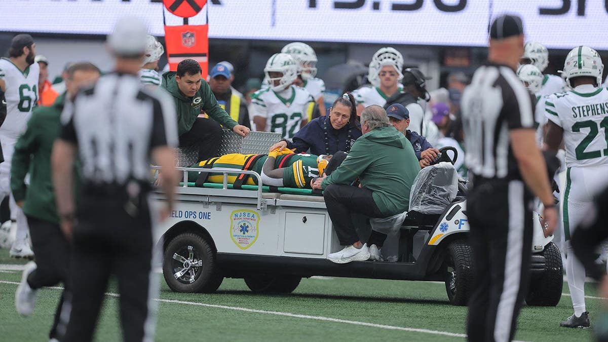 Jayden Reed is carted off the field at MetLife Stadium.