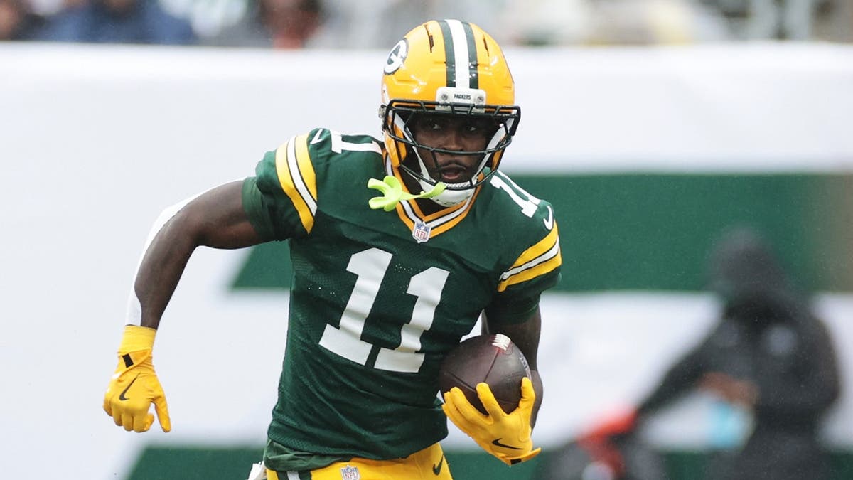 Jayden Reed runs with the ball during an NFL game against the New York Jets.