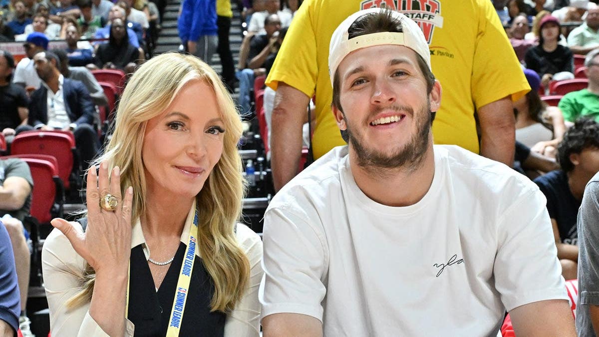 Jeanie Buss and Austin Reaves seated at an NBA Summer League game.
