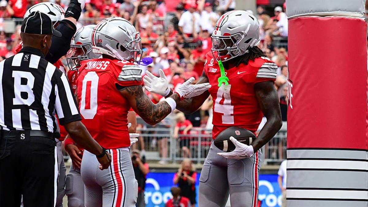 Jeremiah Smith and Brandon Inniss celebrate after Smith's three-yard touchdown catch.