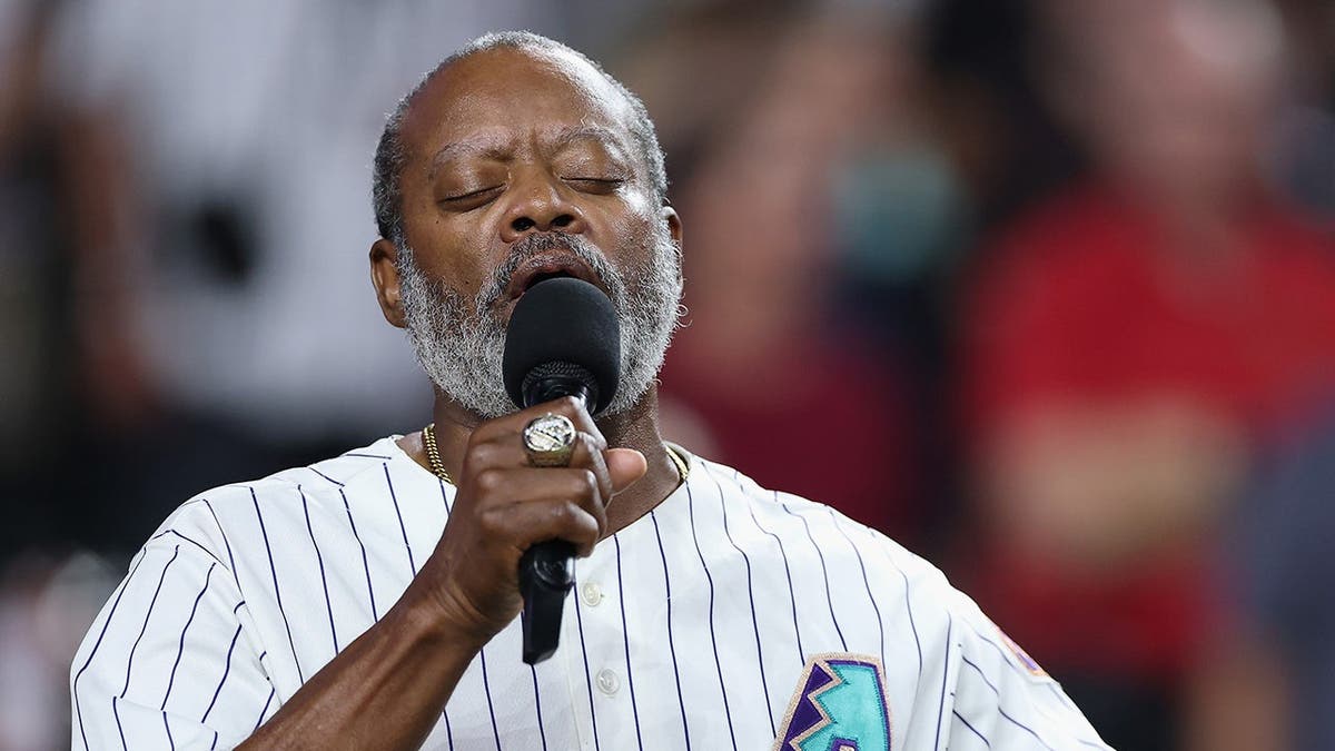 Dr. Jesse McGuire performs during an MLB game at Chase Field in Phoenix.