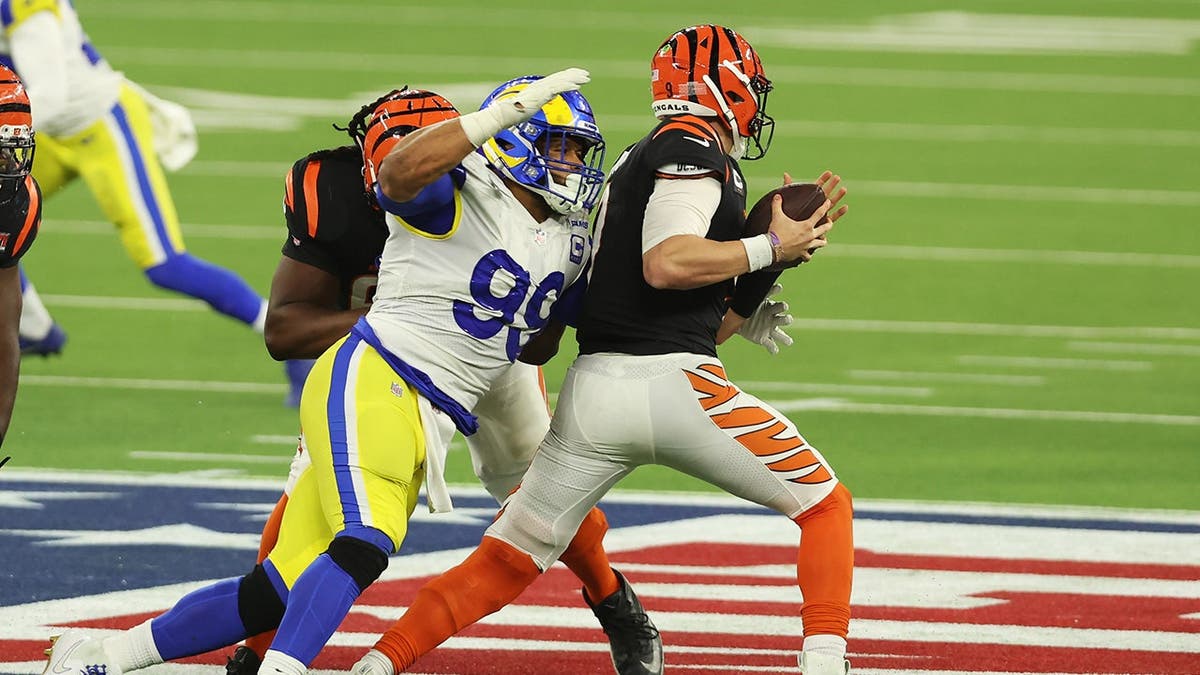 Joe Burrow of the Cincinnati Bengals is sacked by Aaron Donald of the Los Angeles Rams during Super Bowl LVI.