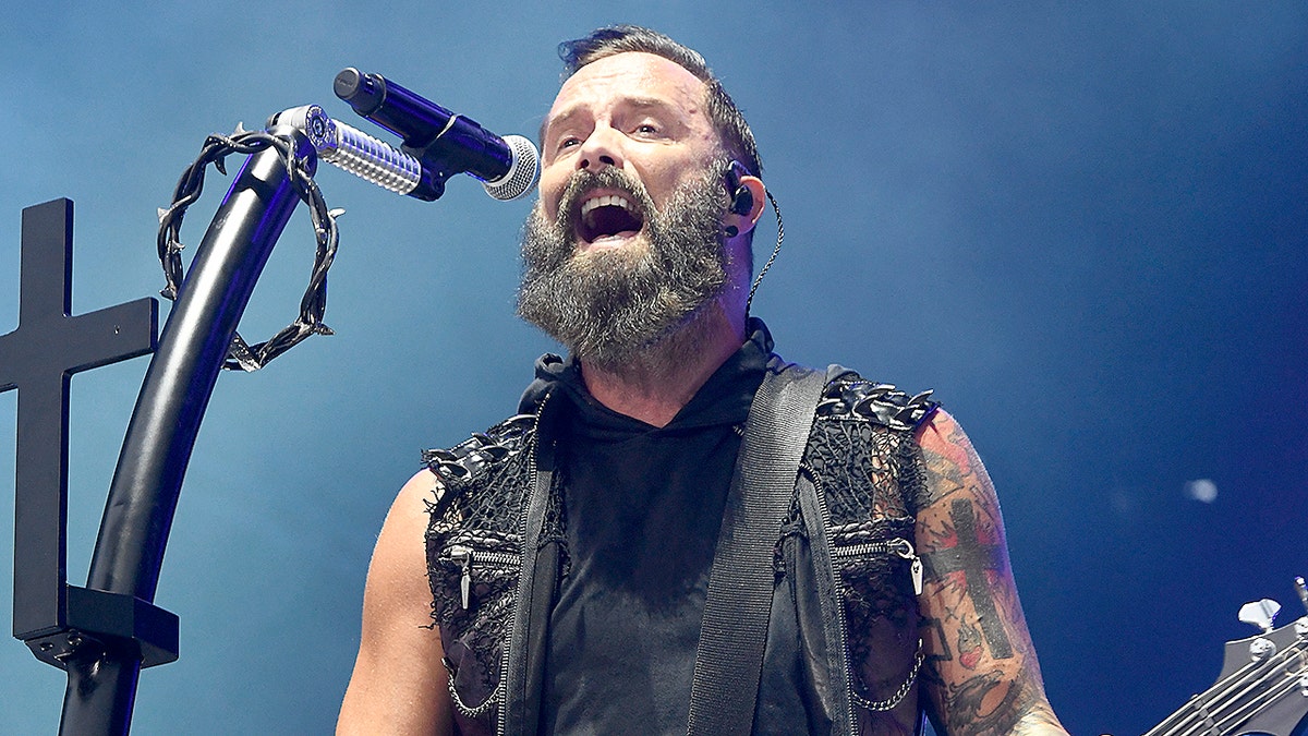 John Cooper sings and plays guitar during concert