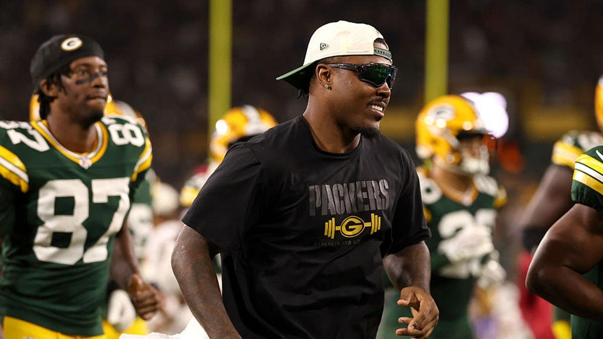 Josh Jacobs runs off the field at Lambeau Field.